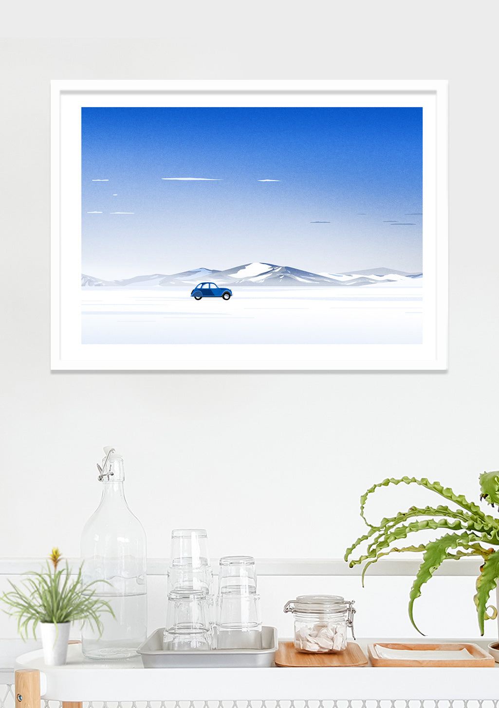 Voiture bleue sur route enneigée, montagnes, ciel bleu clair