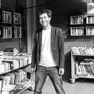 Homme souriant dans une bibliothèque